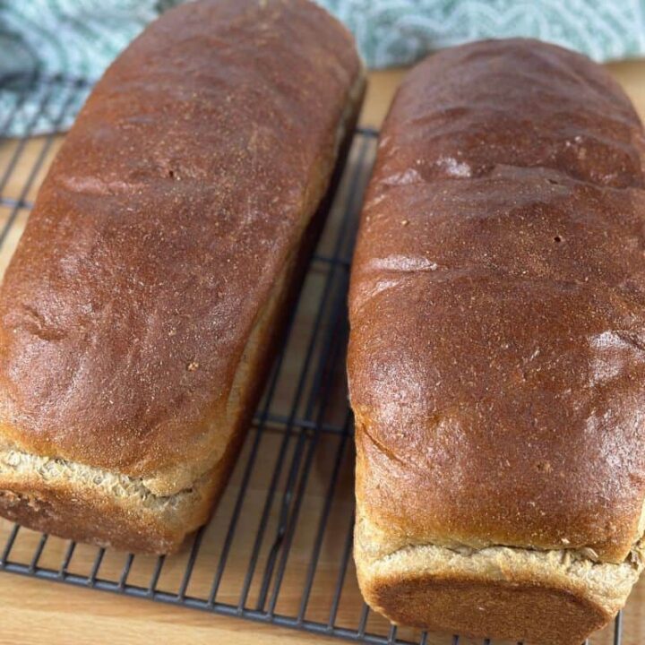 Two loaves of fresh milled flour sandwich bread side by side.