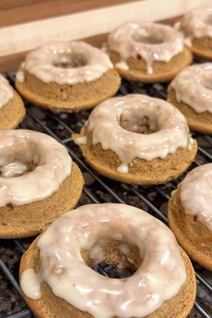 Closeup view of glazed maple cinnamon donuts made with whole grain flours.