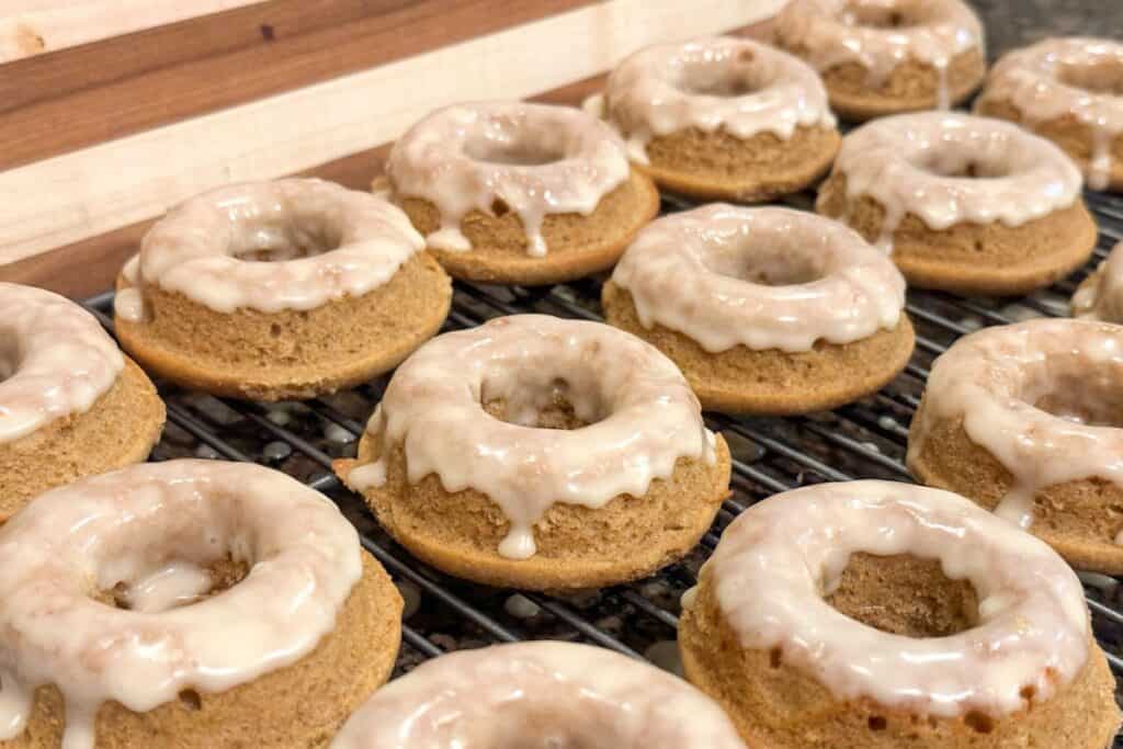 Maple cinnamon donuts with whole grains on a wire cooling rack