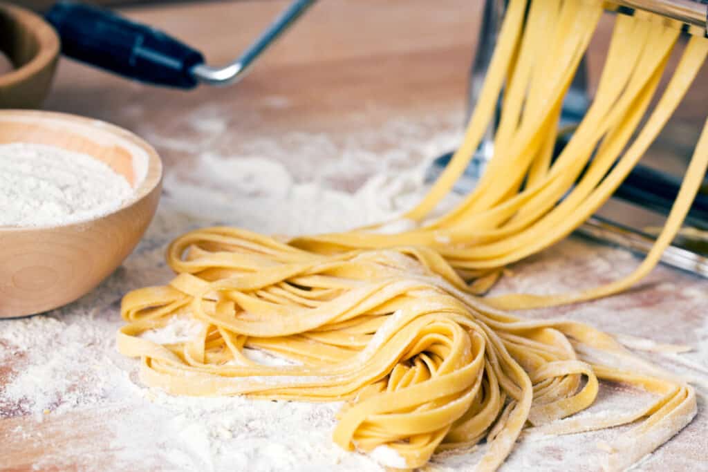Freshly made pasta on a floured surface.