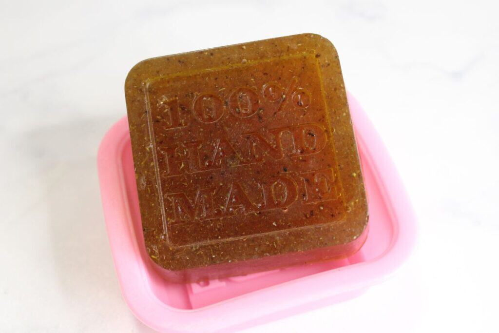 Taking finished soap out of soap molds.