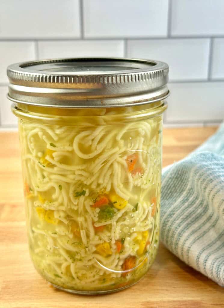 Cooked ramen noodle soup in mason jar ready to eat.