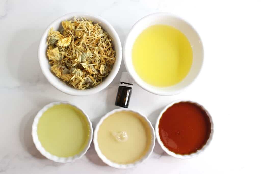 Calendula honey cleanser ingredients in ceramic bowls, top view.