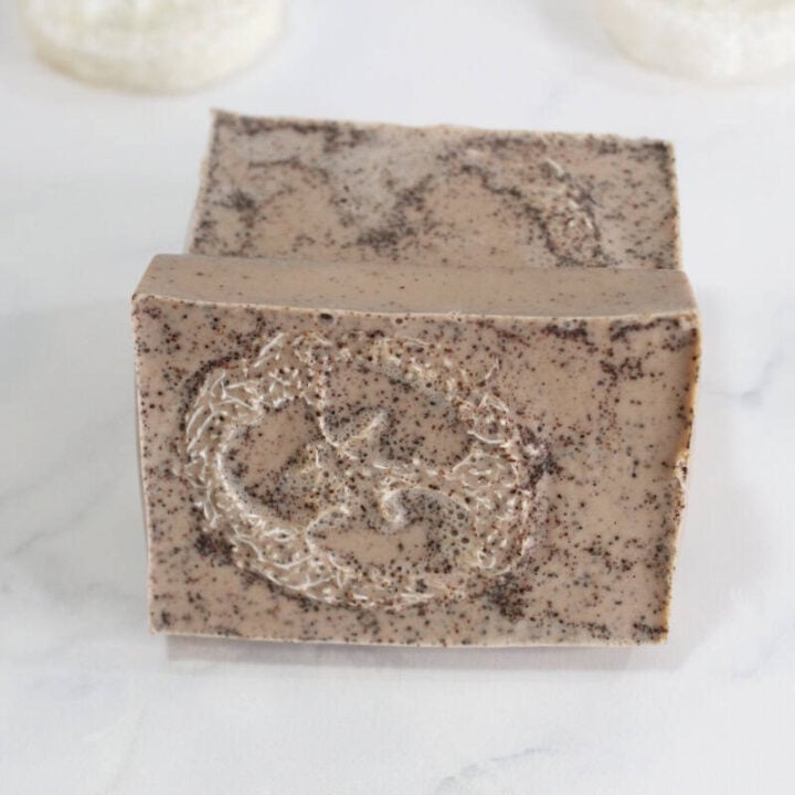 Two loofah soap bars on white countertop.