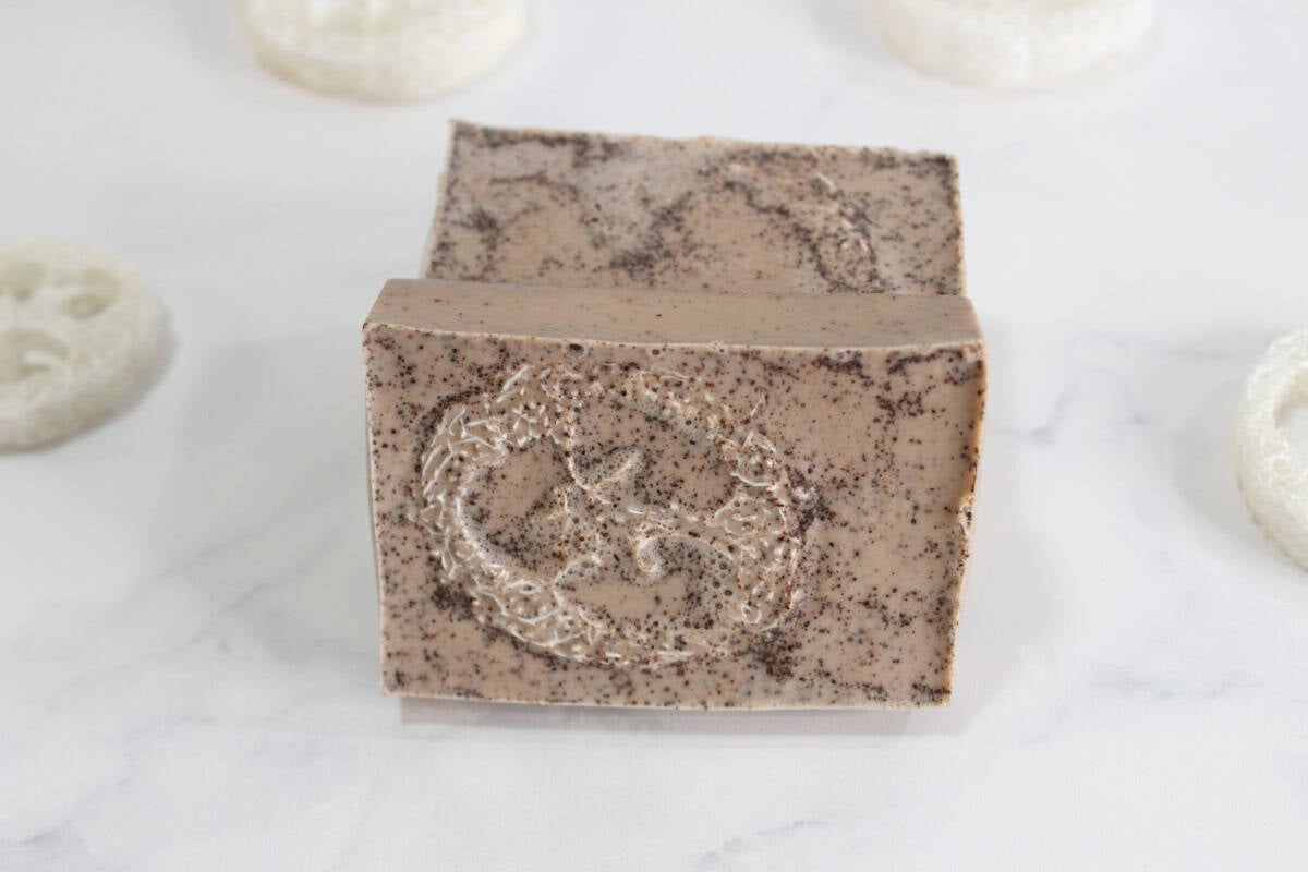 Two loofah soap bars on white countertop.