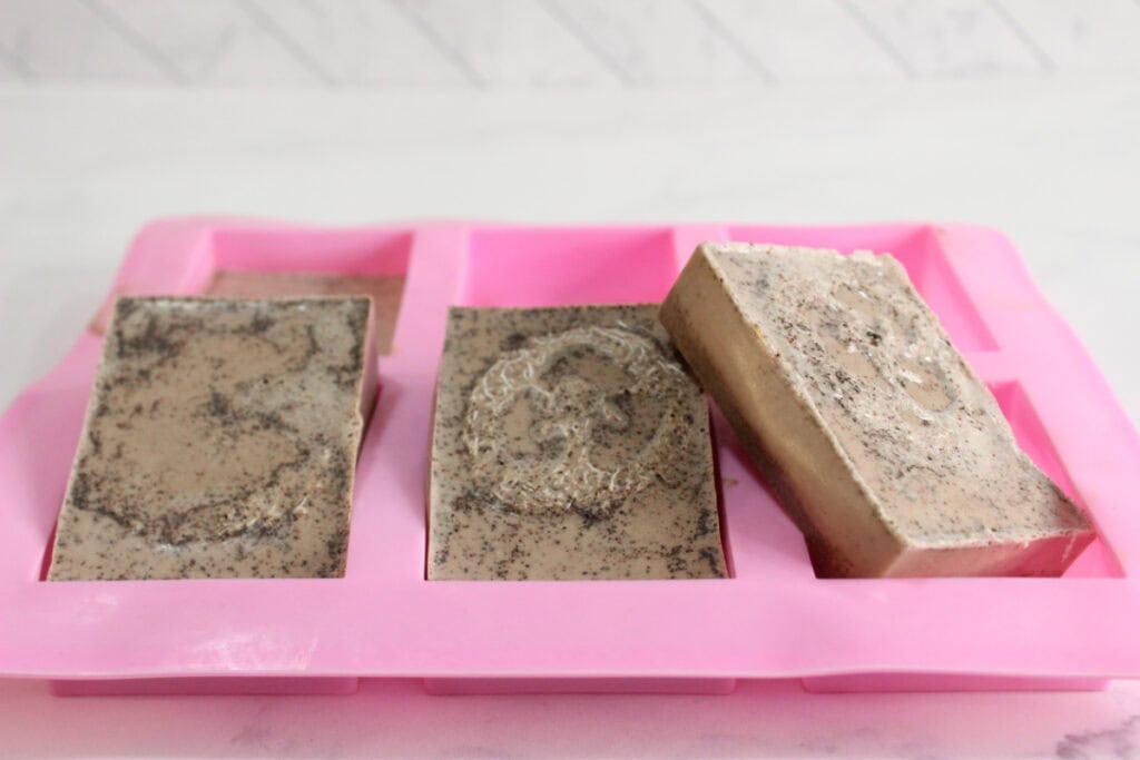 Three soap bars popped out of the mold after hardening.