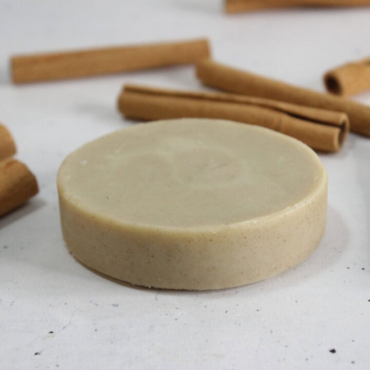 lotion bar on table with cinnamon sticks.