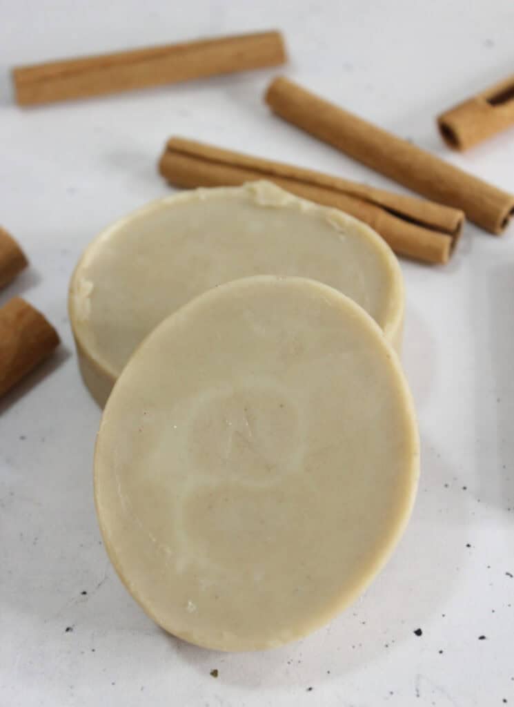Two solid lotion bars on white countertop.