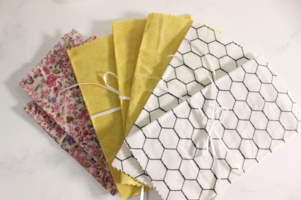 7 Folded beeswax wraps tied with ribbon.