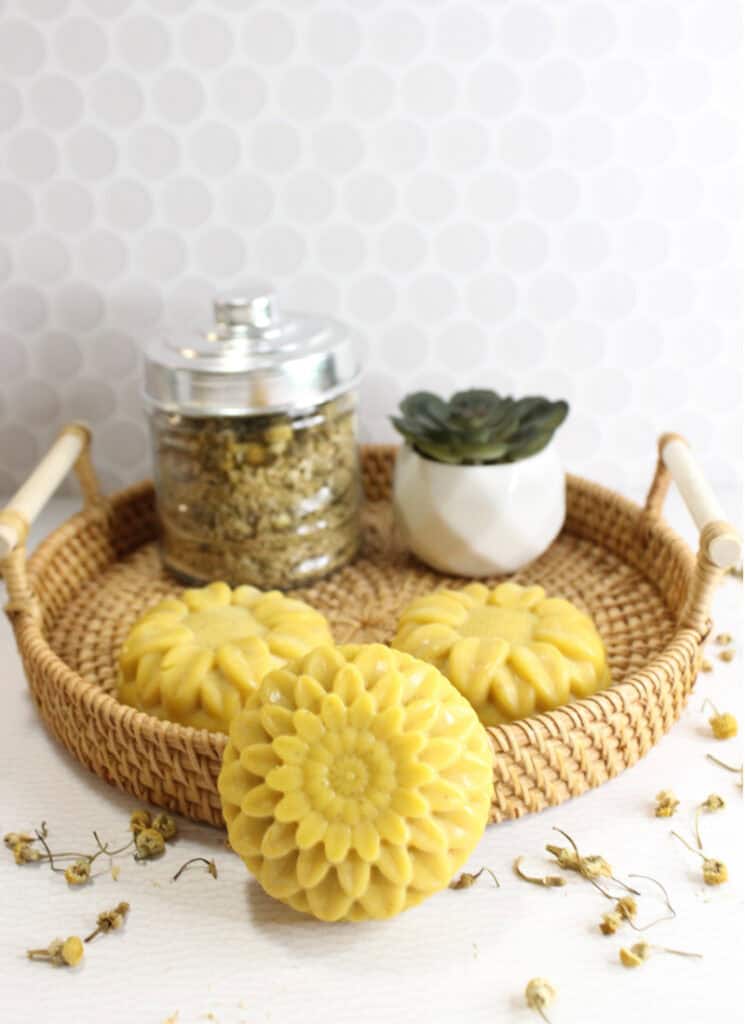 Rattan basket with 3 chamomile infused soap bars in flower shapes.