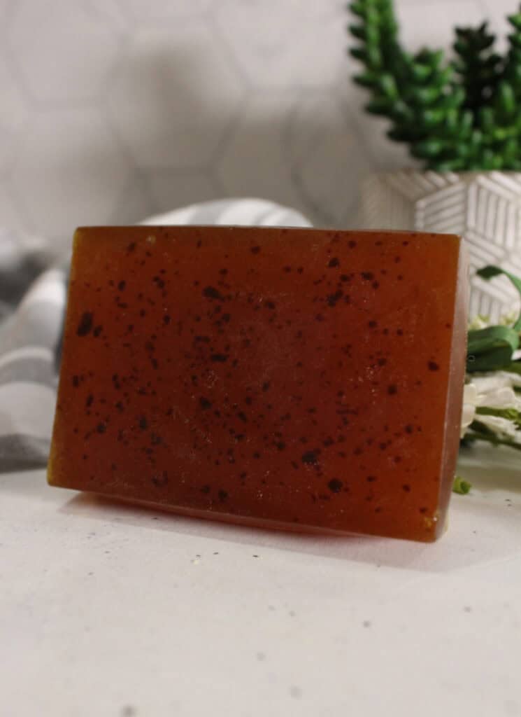 Turmeric soap bar- vertical photo on white and grey background.