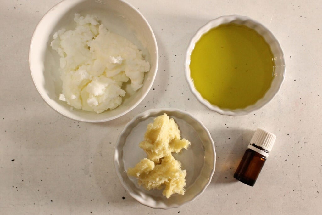 rose body butter ingredients on speckled countertop.
