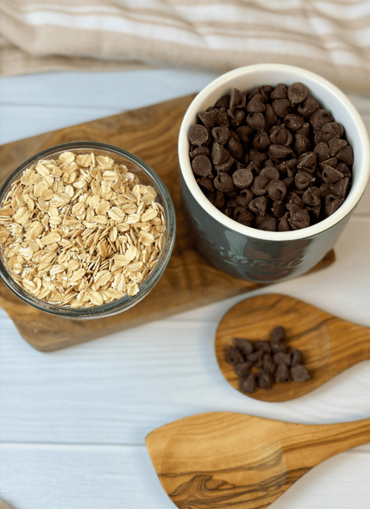 up close photo of 2 containers holding chocolate chips and old fashioned rolled oats.