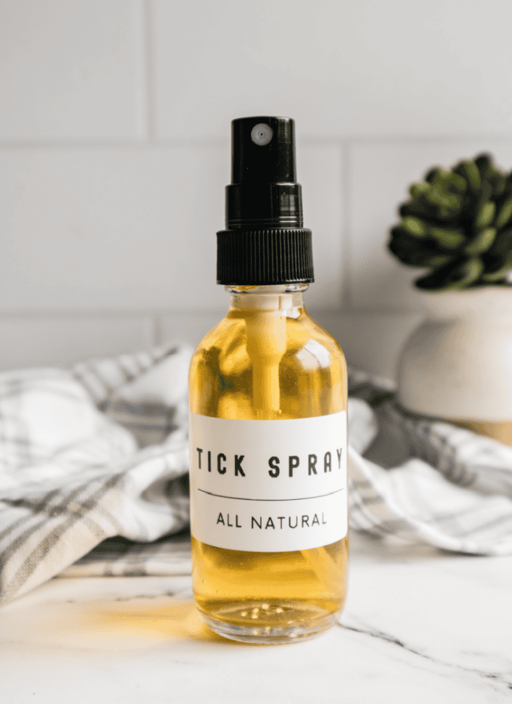Bottle of homemade tick spray with "tick spray- all natural" label.